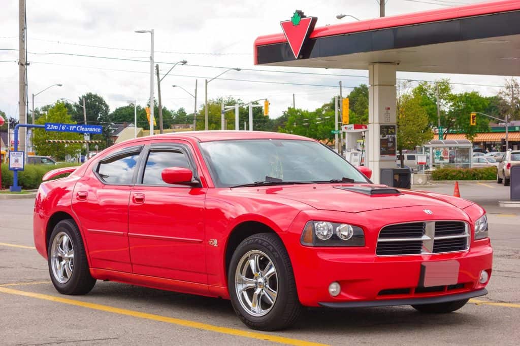 Red colored first generation Dodge Charger LX parked in a parking lot