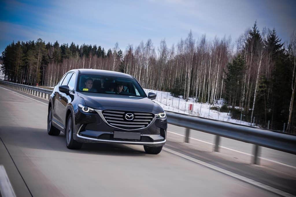 Second generation of Mazda CX-9 drives on a highway during the test-drive event