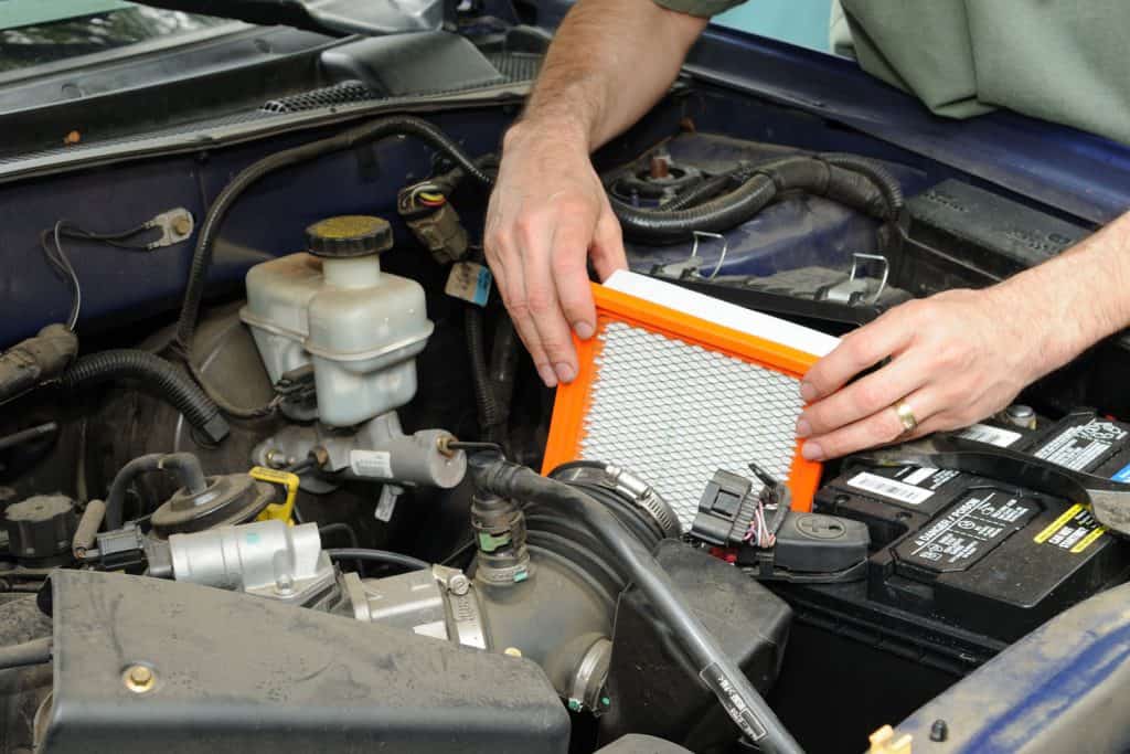 Technician changing the air filter for the car AC