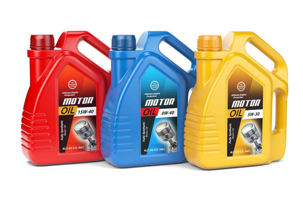 Three different types of motor oil on a white background