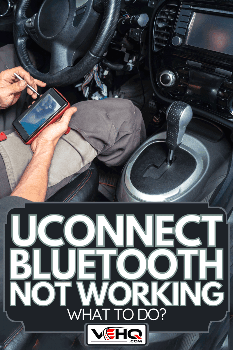 Electrician connecting a phone application to a car dashboard, Uconnect Bluetooth Not Working - What To Do?
