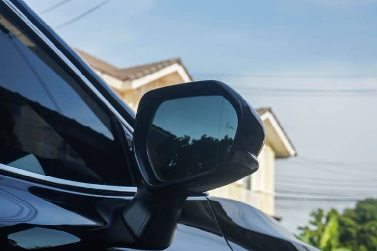 close up side view mirror of the black luxury car with blind spot monitor system, Does The Hyundai Accent Have Blind-Spot Monitoring?