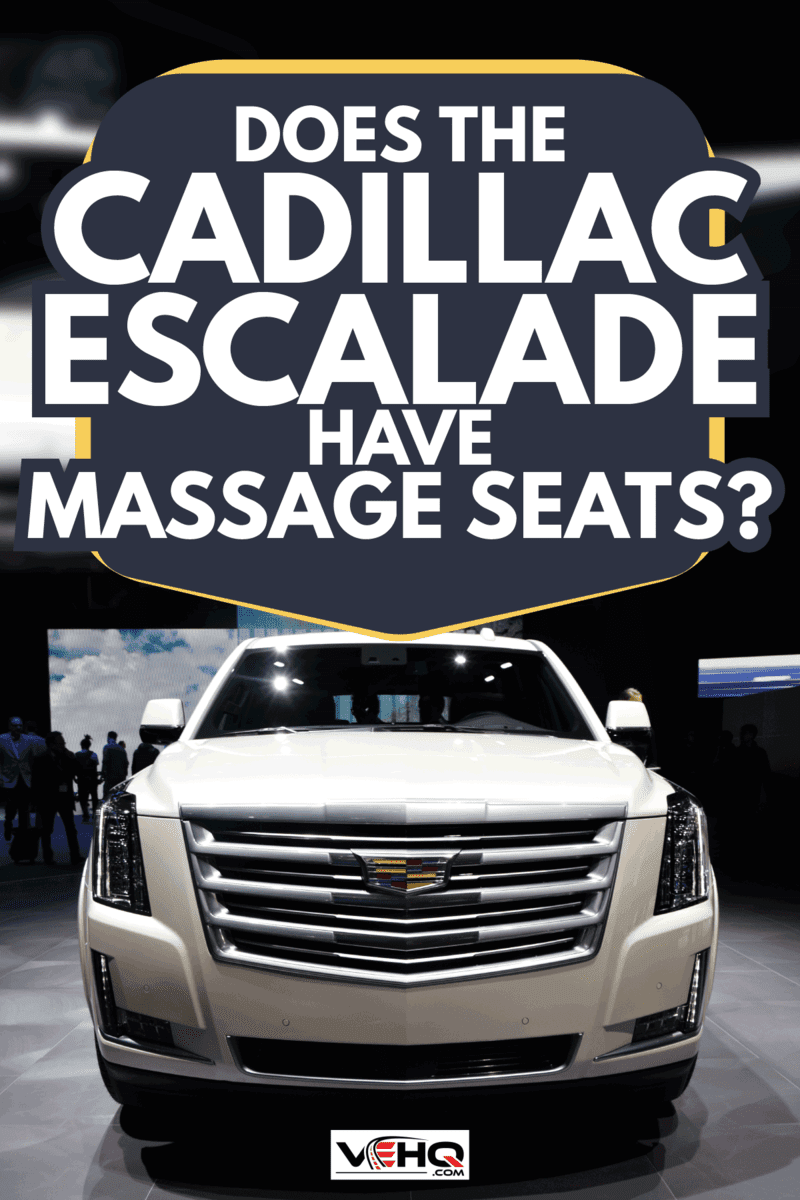 front view of a white Cadillac Escalade under low light. Does The Cadillac Escalade Have Massage Seats