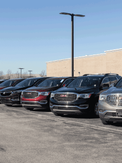 row of parked Buick SUVs and crossovers at a dealership lot. How Big Is The Buick Envision [Dimensions Explored]
