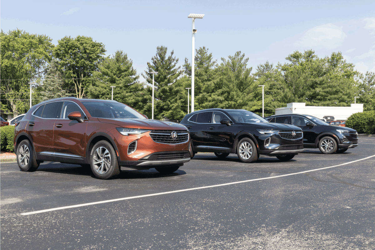 three Buick Envision cars, brand new, on display at a dealers lot