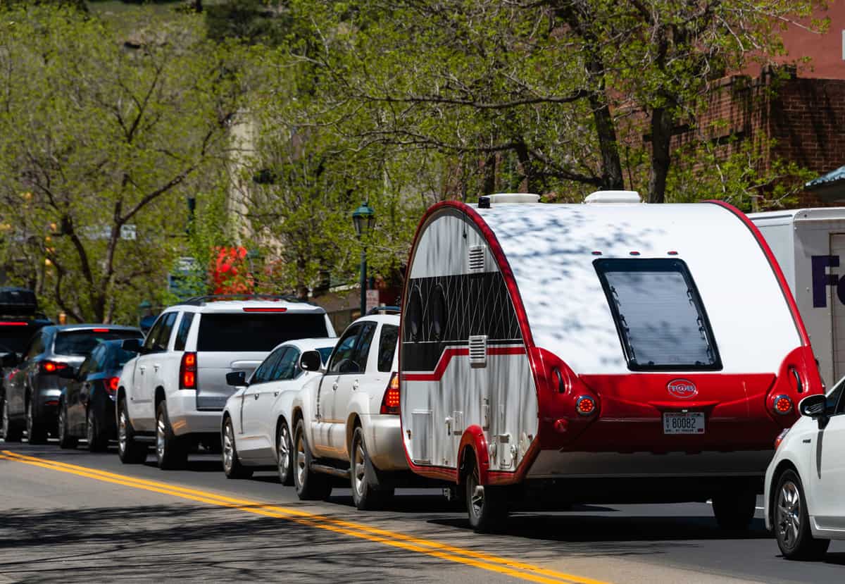 A beautiful tear drop camper sits in traffic in the resort city of Estes Park, Colorado.