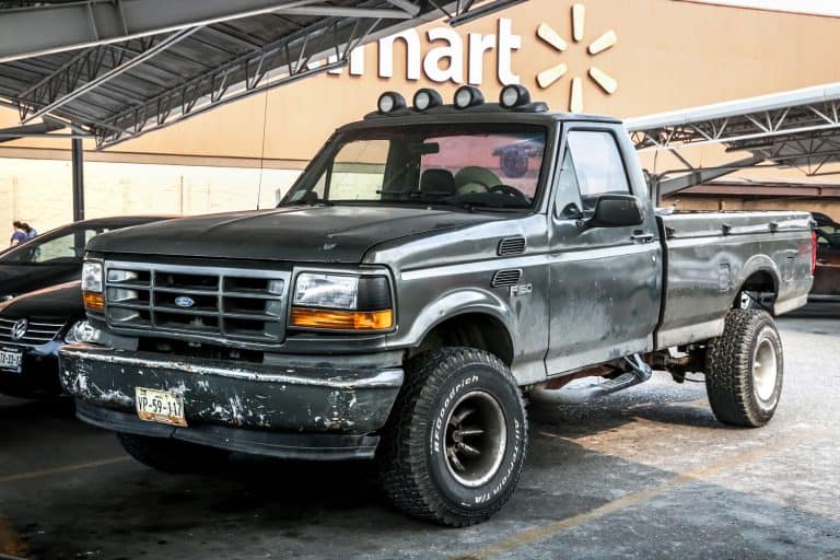 A black single cab Ford F150 parked at Walmart, How To Patch A Rust Hole In A Truck Bed