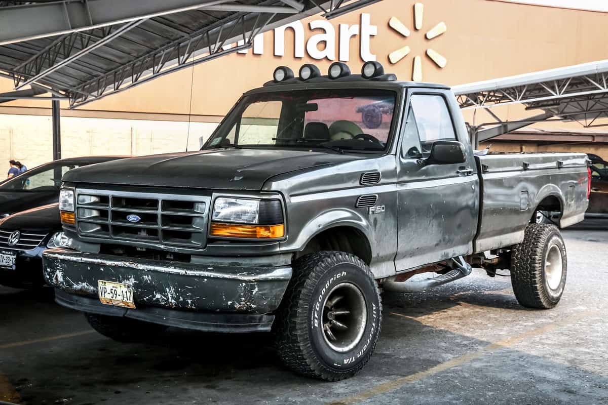 A black single cab Ford F150 parked at Walmart