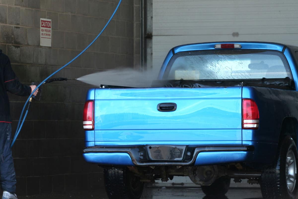 A blue truck at a car wash