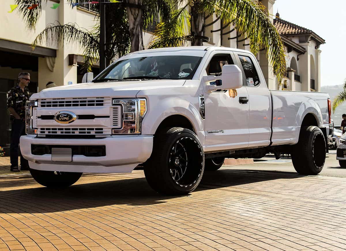 A large and modified Ford F-250 seen leaving a largely known car show in Southern California