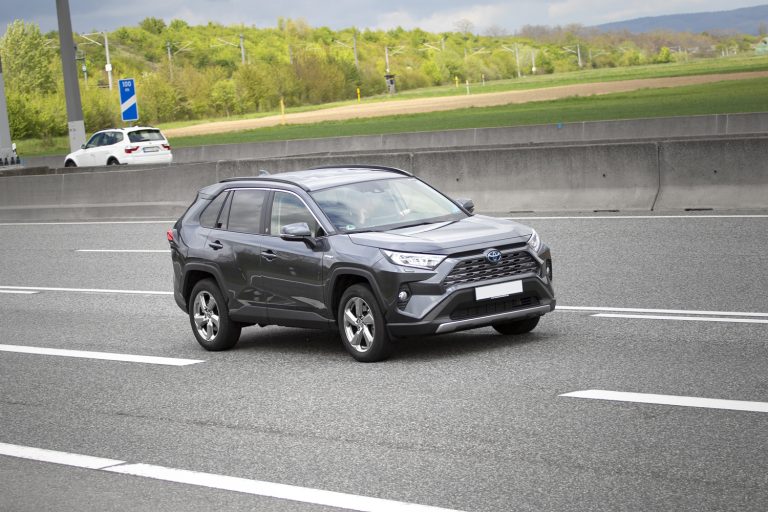 A middle-aged man in Toyota RAV4 Hybrid driving on a highway - Does Toyota RAV4 Have Heated Seats