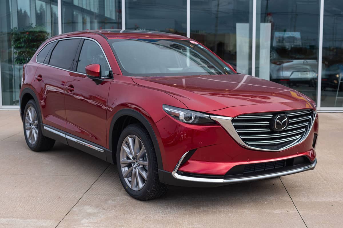 A red colored Mazda CX9 displayed at a car dealership