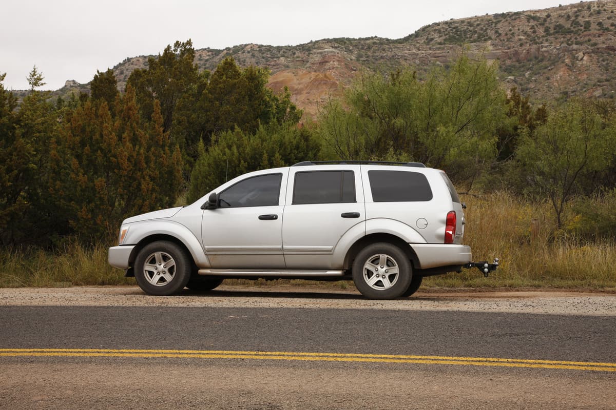 A silver 2004 Dodge Durango parked beside the road