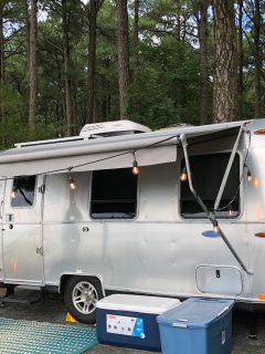 An Airstream Sport travel trailer parked at a campground, How Much Does An Airstream Camper Cost?