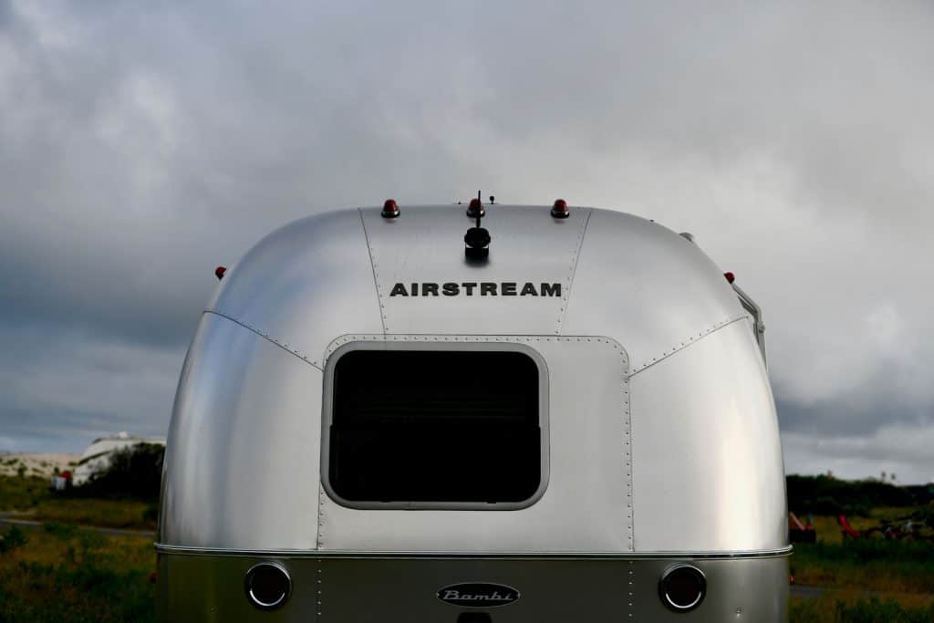 An Airstream Sport travel trailer parked at a campground