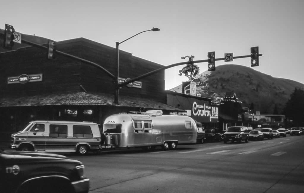An Airstream trailer from the 1950s - 1960s, still in perfect use, passes through the streets of Jackson Hole on its way to Yellowstone N.P