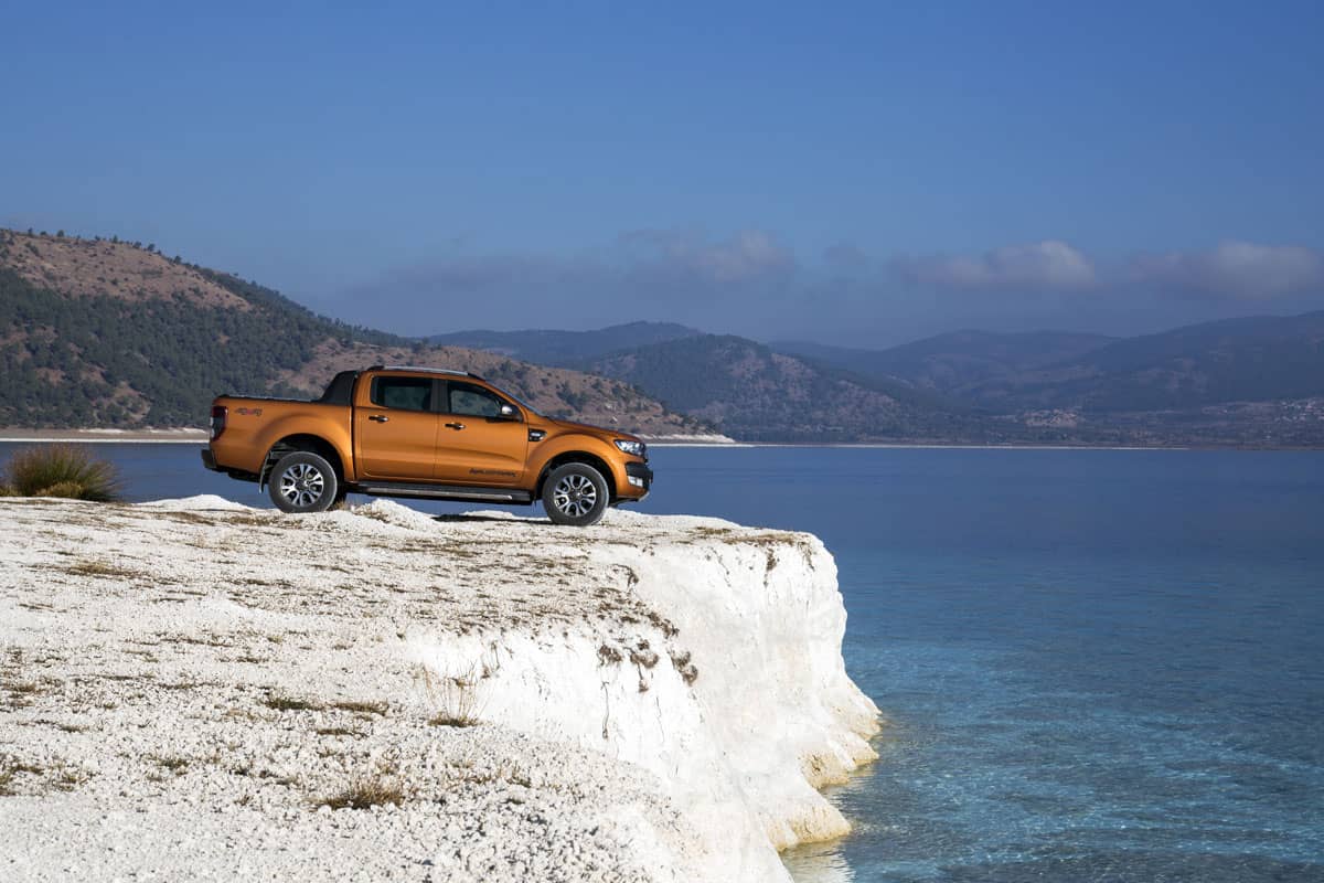 An orange Ford Wildtrak 4x4 truck on terrain for testing in October 2017 launch of the model