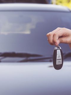 Car owner handling car keys to the valet, Can You Drive With A Valet Key? [And How Fast Can You Go?]