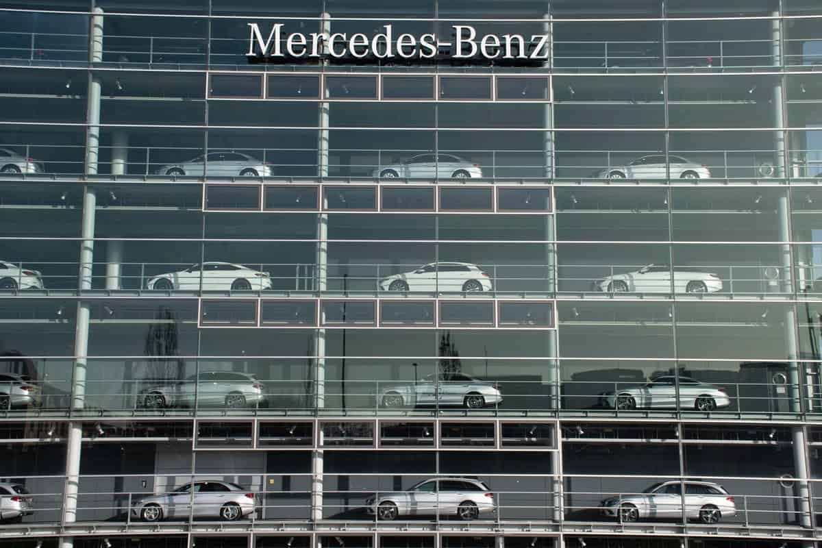 Cars for sale on display in the windows of the Mercedes-Benz building.