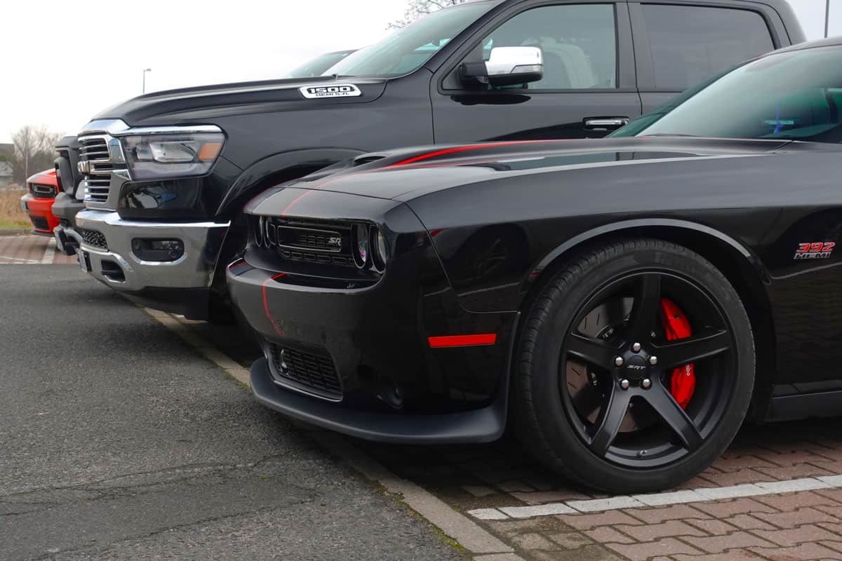 Dodge Challenger SRT and RAM 1500 pick-up vehicles parked on a public parking