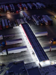 Dozens of trucks parked at a truck stop while being refueled, How Long Are Showers At Truck Stops?