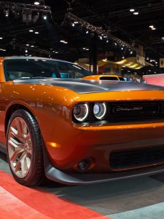 Front view of an orange Dodge Challenger displayed - How To Change A Dodge Charger Headlight Bulb