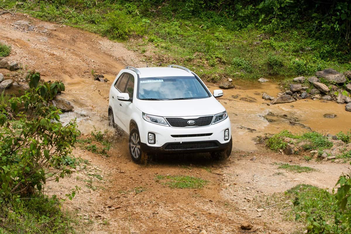 Kia New Sorento car is running on the mountain road in test drive