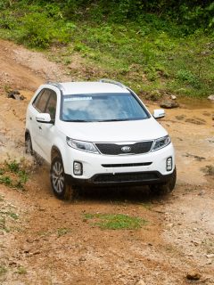 Kia New Sorento car is running on the mountain road in test drive, How To Put A Kia Sorento In 4WD Or AWD