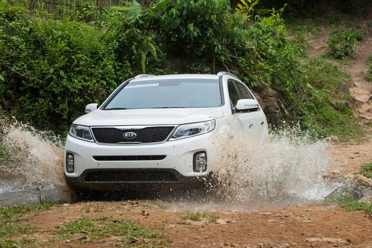 Kia Sorento car is running on the mountain road in test drive