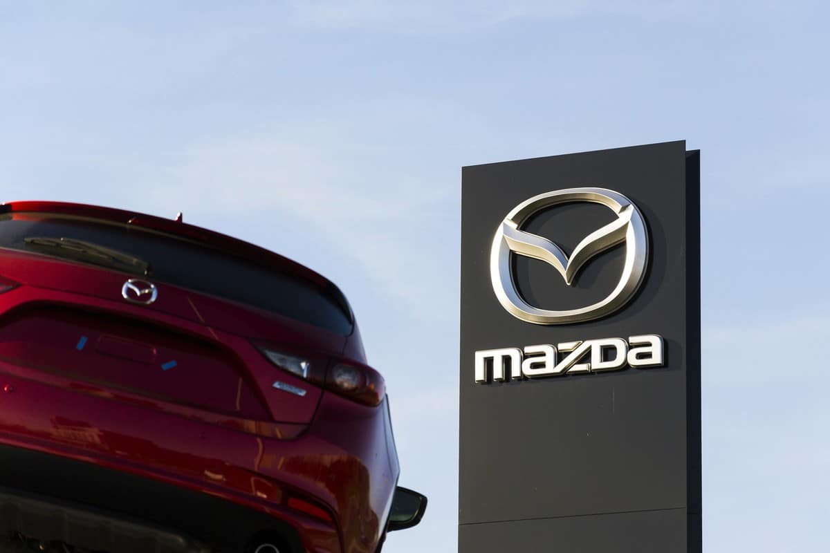 Mazda 3 car in front of dealership building