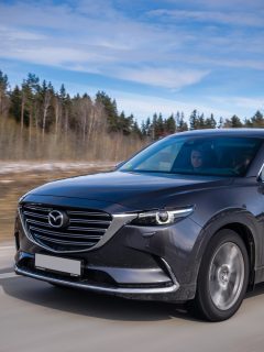Second generation of Mazda CX-9 drives on a highway during the test-drive event. Mazda CX-9 is a truly striking 7-passenger SUV. - Can Mazda CX-9 Be Flat Towed