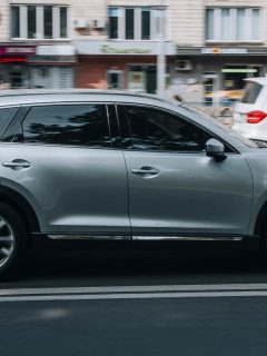 A silver MAZDA CX-9 car moving on the street, Can A Mazda CX-9 Tow A Trailer?