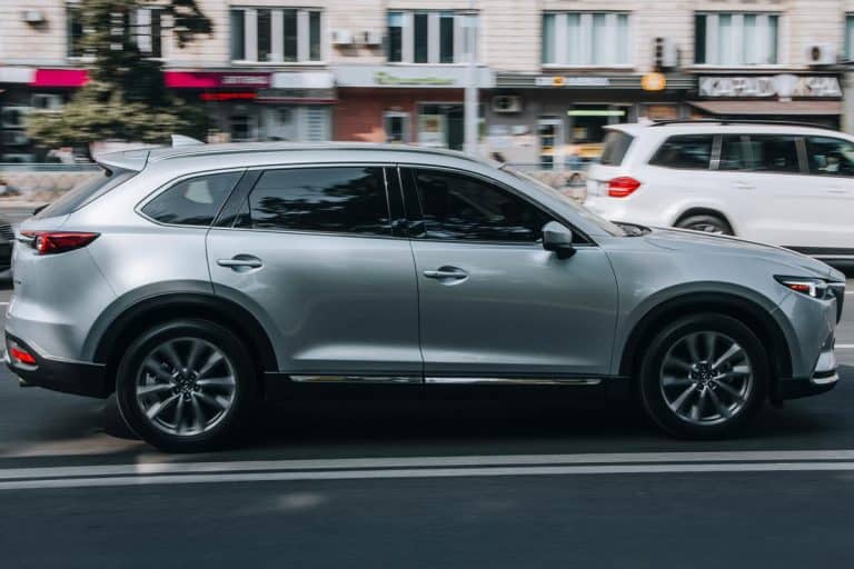 A silver MAZDA CX-9 car moving on the street, Can A Mazda CX-9 Tow A Trailer?