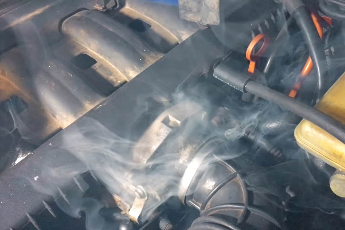Smoke under the hood of a car. Car engine smokes.