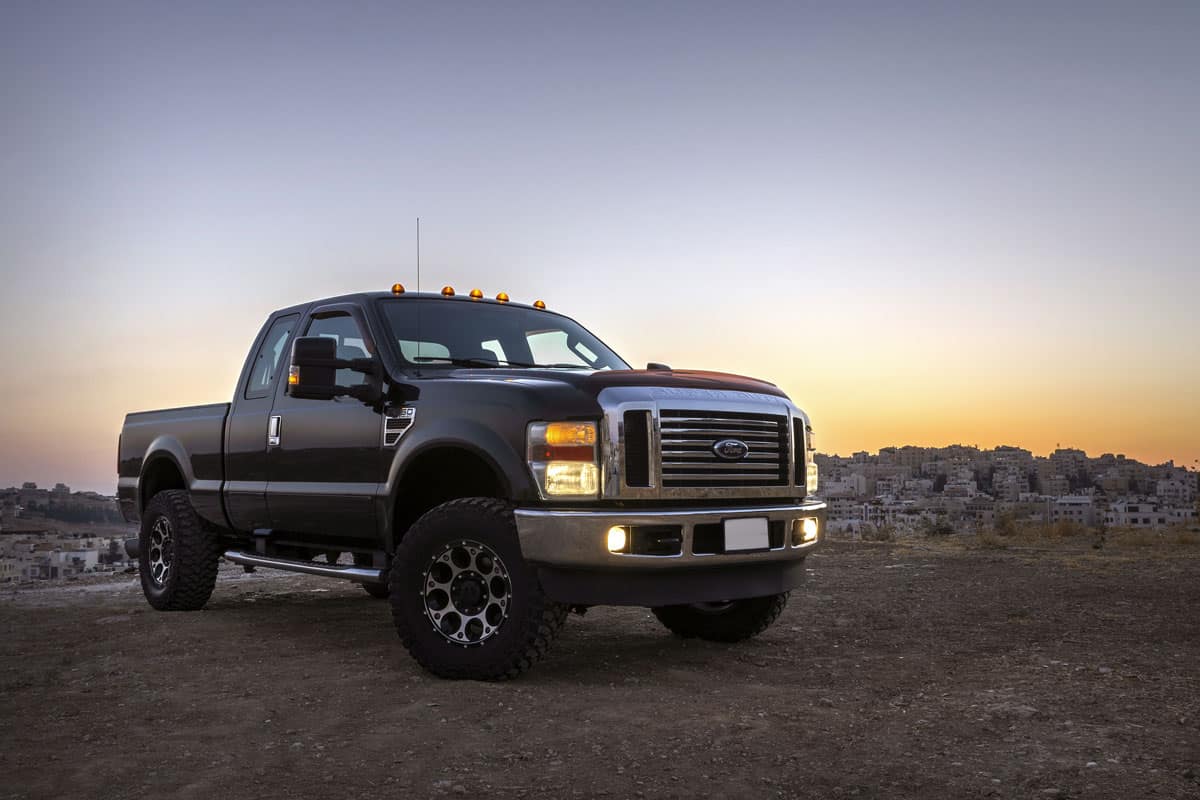 Super duty ford truck at a isolated plain road sunset