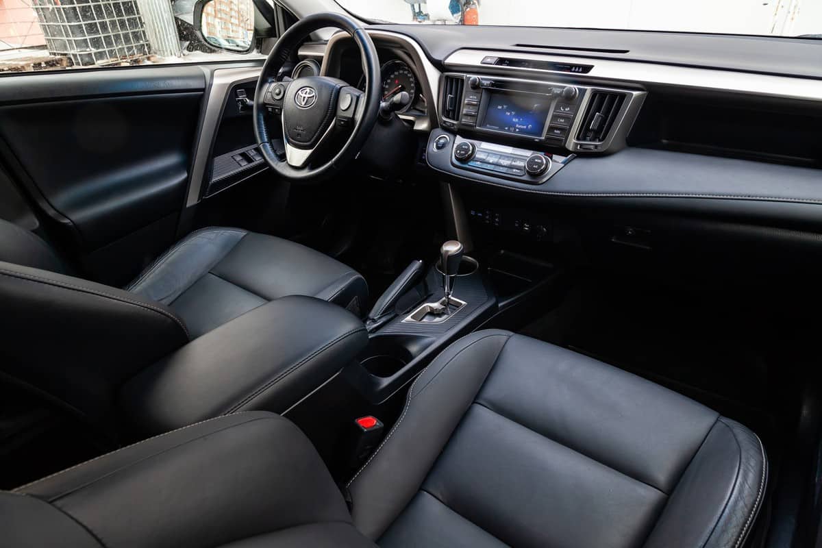 The interior of the car Toyota Rav4 with a view of the steering wheel, dashboard, seats and multimedia system