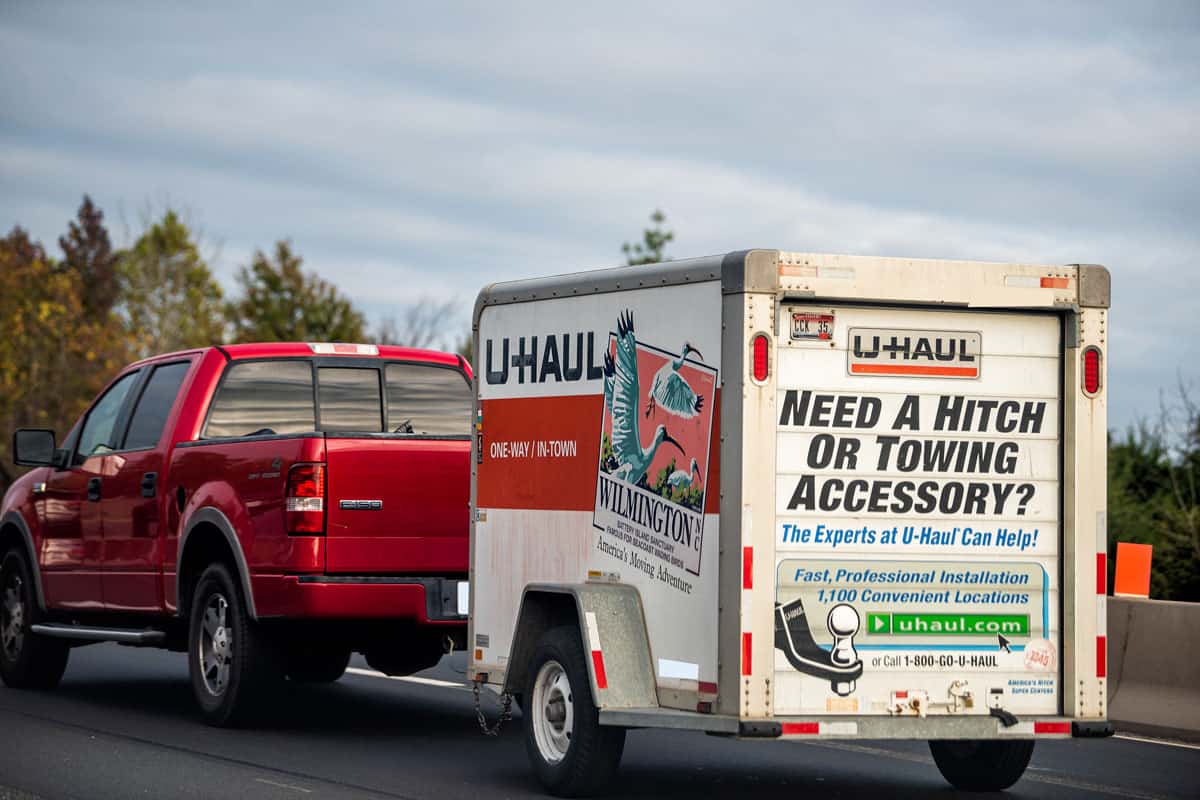 U-Haul trailer attached to Ford F-150 pickup truck relocating moving to another country