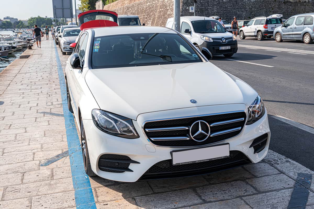 White Mercedes C-class in a parking lot in the city of Zadar, Croatia. 