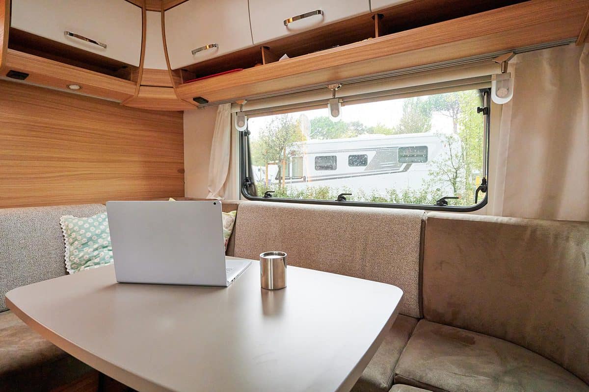 Working in a caravan with a laptop on holiday travel