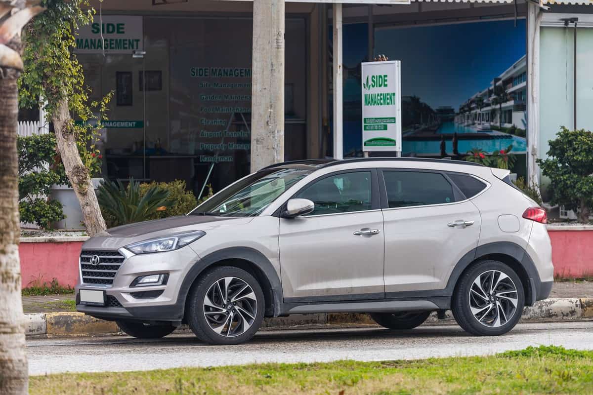 beige Hyundai Tucson is parked on the street 