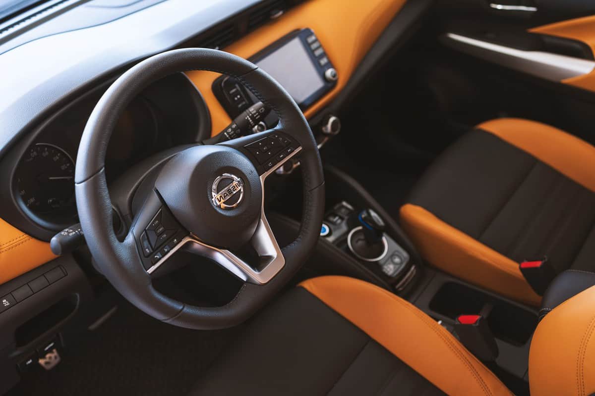 closeup interior in the All-New NISSAN KICKS e-POWER with soft-focus and over light in the background