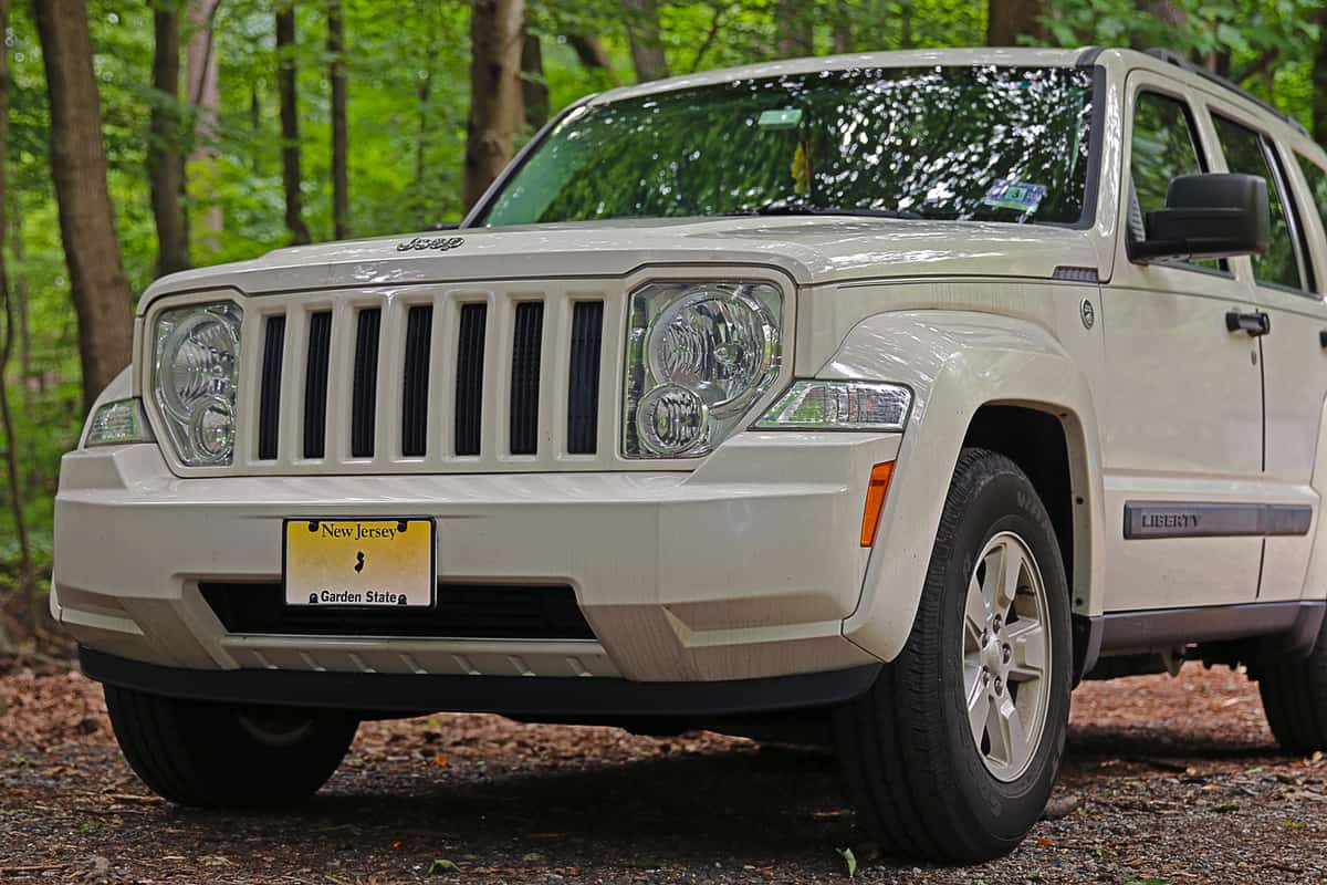 A 2010 Jeep Liberty parked in a wooded area which is used by off-road enthusiasts to test the capabilities of their vehicles.