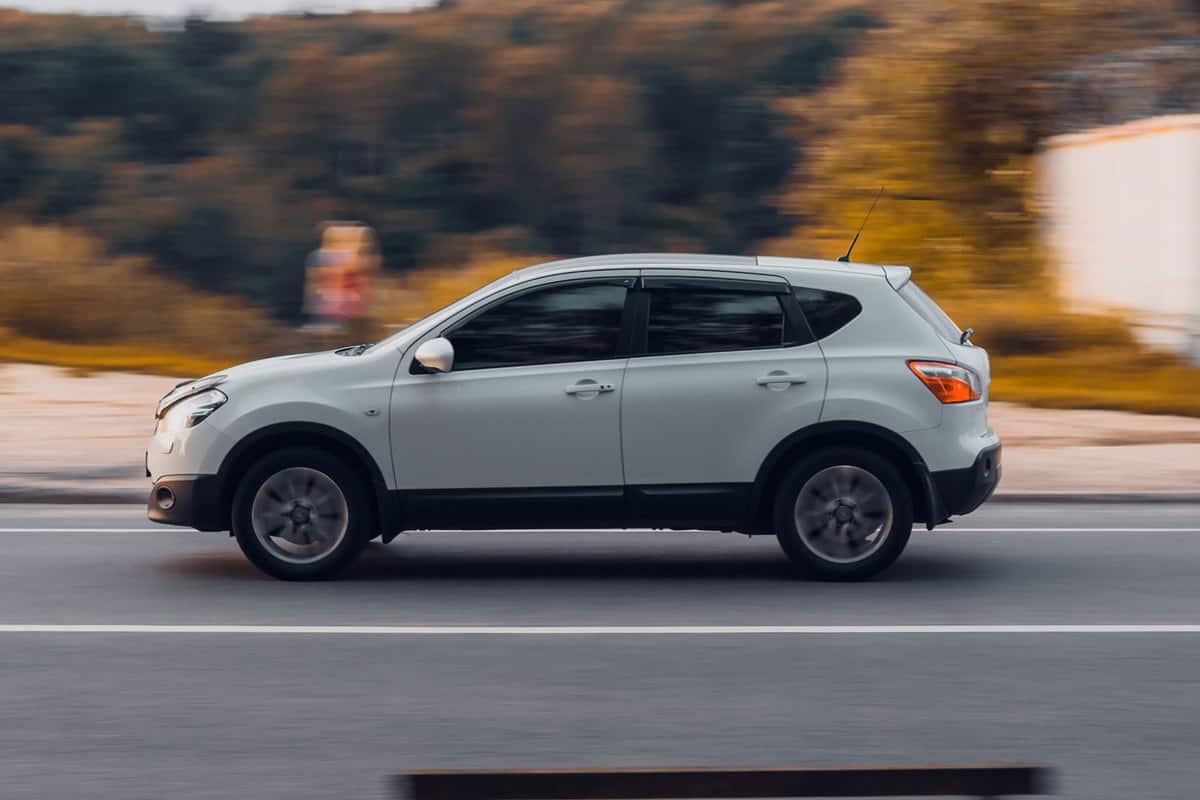 A Nissan Rogue moving fast on the highway