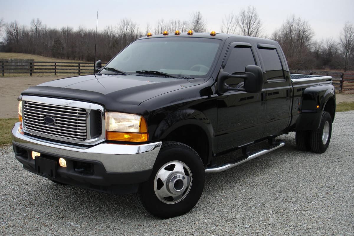A black dually Ford F-350 with lights on top