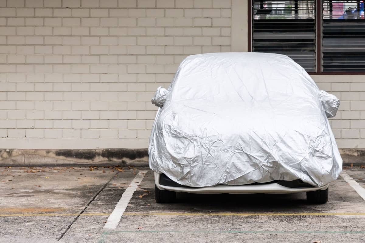 A covered car at a parking lot