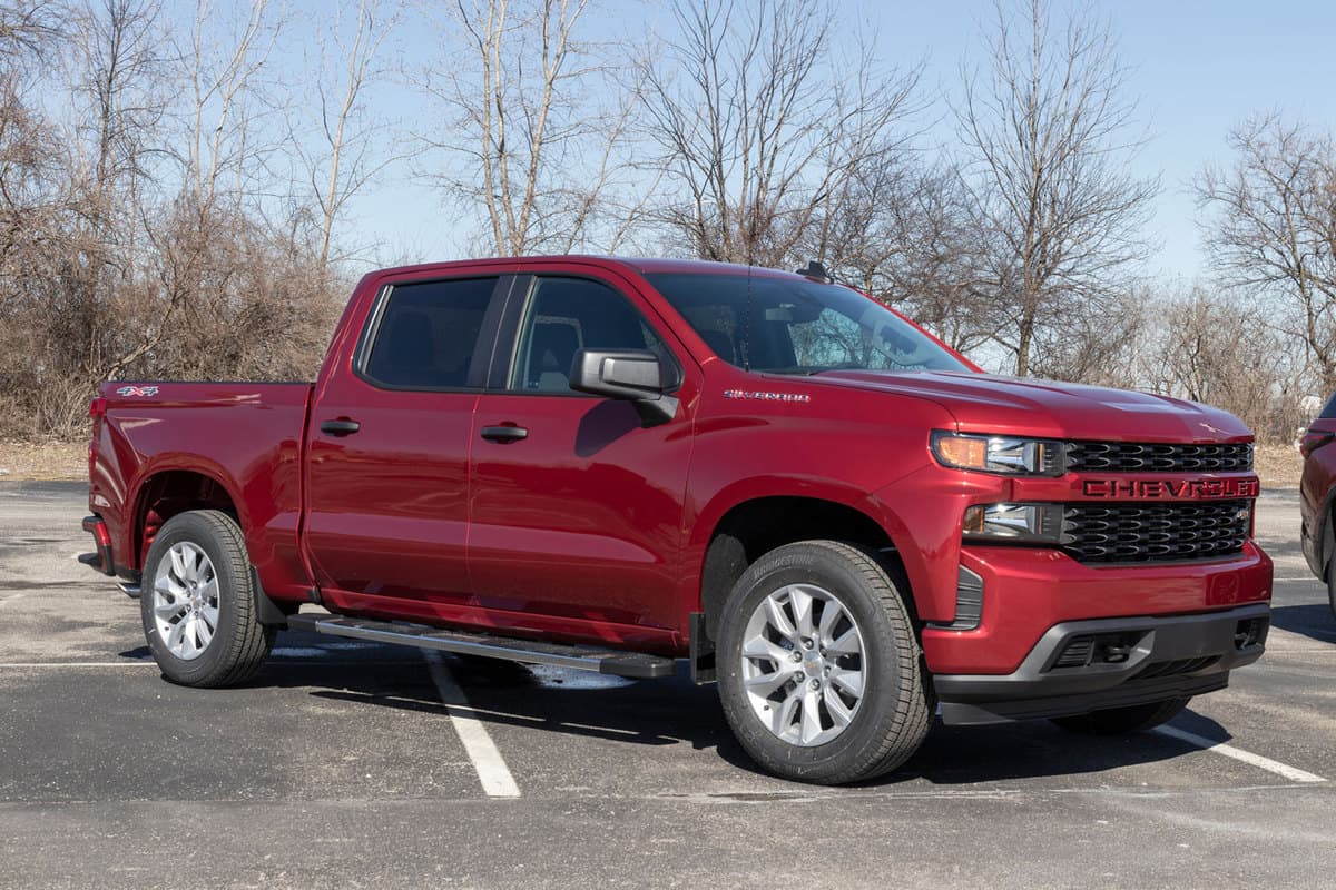 A red Chevrolet Silverado photographed at a parking lot