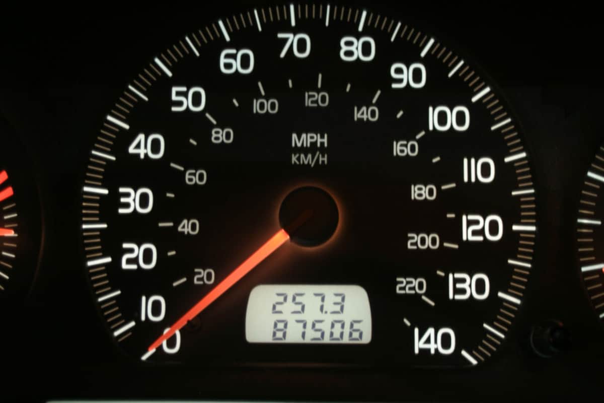 An up close photo of a cars odometer
