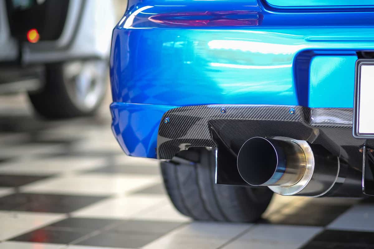 Blue backend of a car with carbon fiber spoilers and high end titanium exhaust pipe