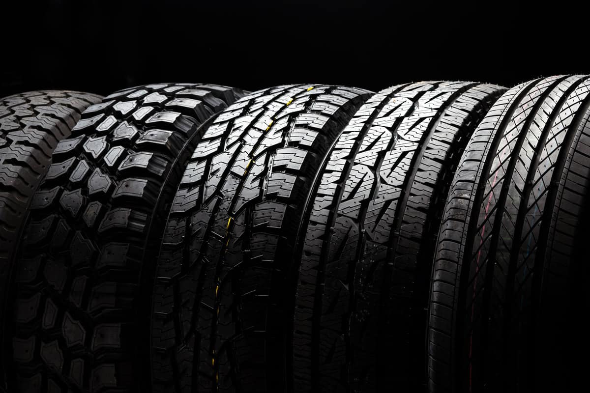 Brand new radial car tires on a black background