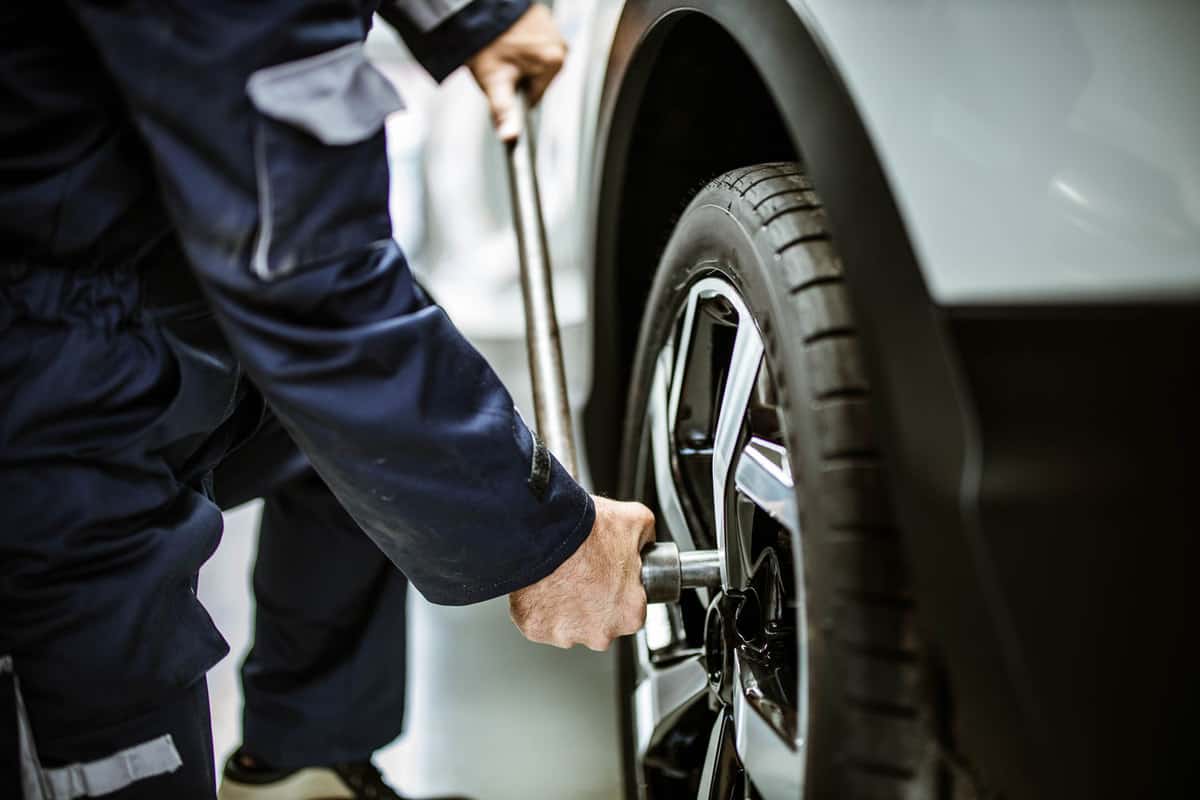 Car mechanic changing new car tires
